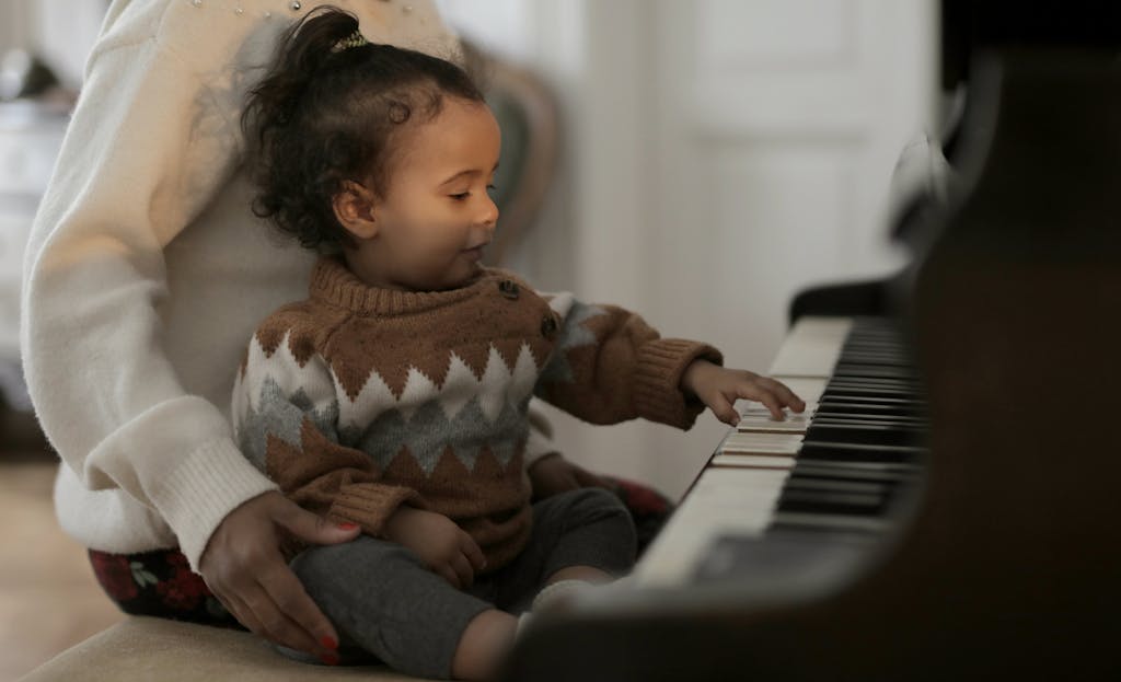 Girl in Brown Sweater Playing Piano